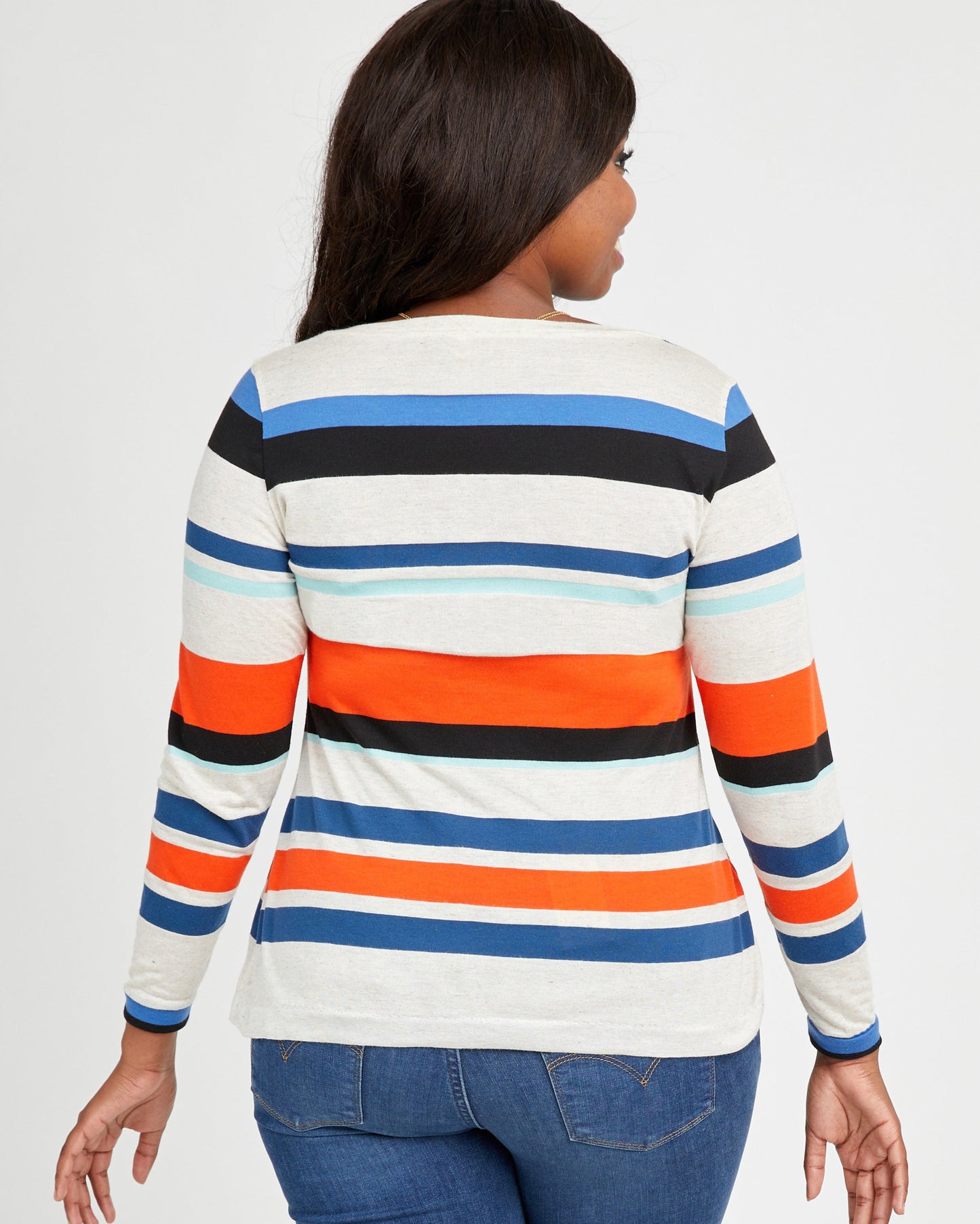 Woman wearing a striped long-sleeve shirt with a white background. This t-shirt is the Concord T-Shirt sewing pattern from Cashmerette.