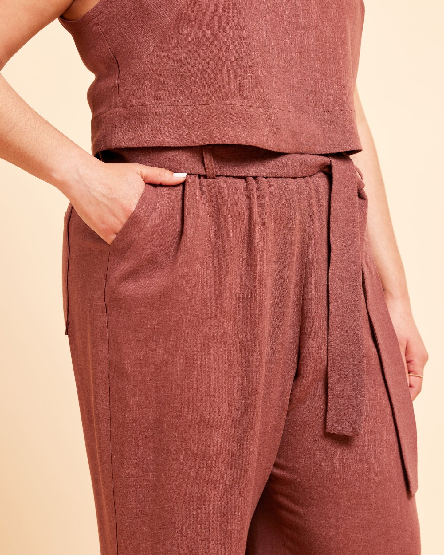 Brown sleeveless top and pants set on a beige background. These pants are the Everett Pants & Shorts sewing pattern from Cashmerette.