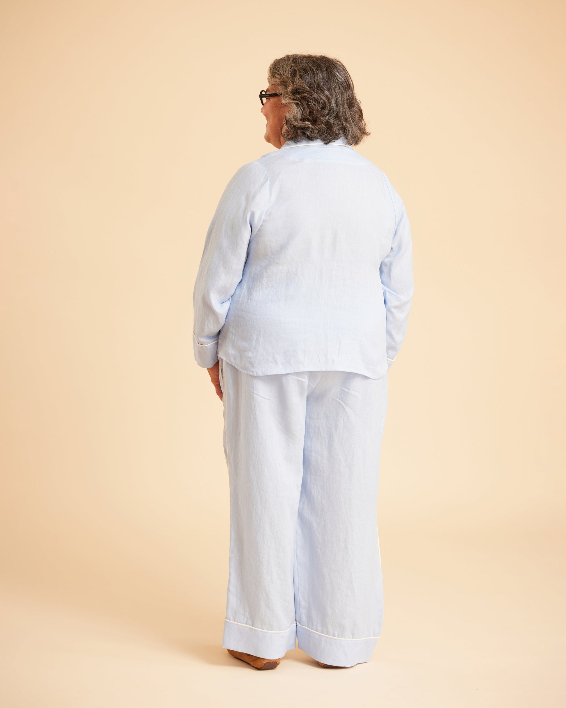 Person wearing a light blue outfit on a beige background. This is the Fiske Sleepwear Set sewing pattern from Cashmerette.