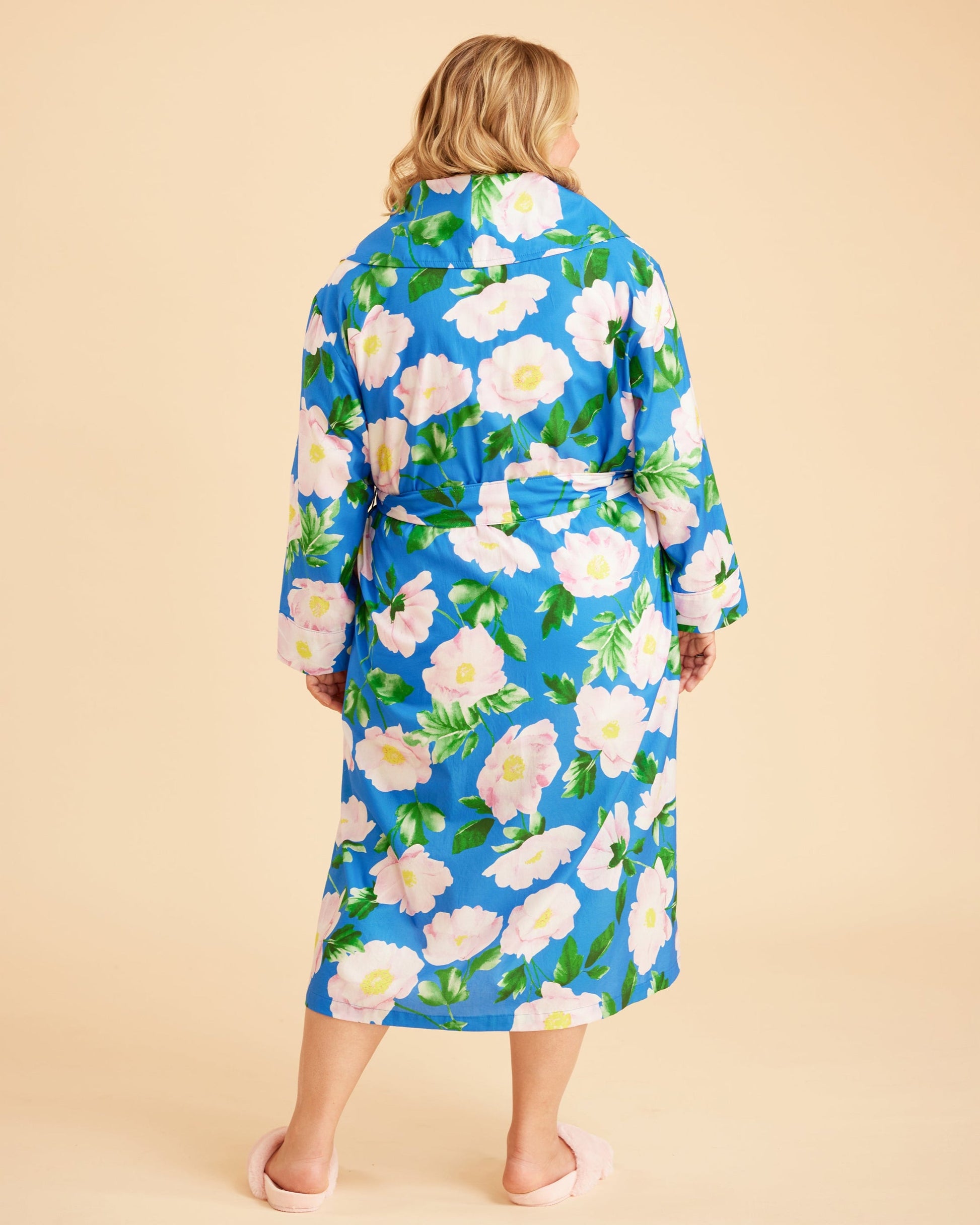 Woman wearing a blue floral robe against a beige background. This is the Fiske Sleepwear Set sewing pattern from Cashmerette.