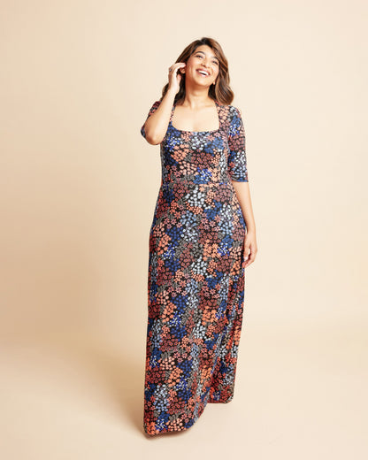 Woman wearing a floral dress on a beige background. This is the Grafton Dress, Top & Skirt sewing pattern from Cashmrette.