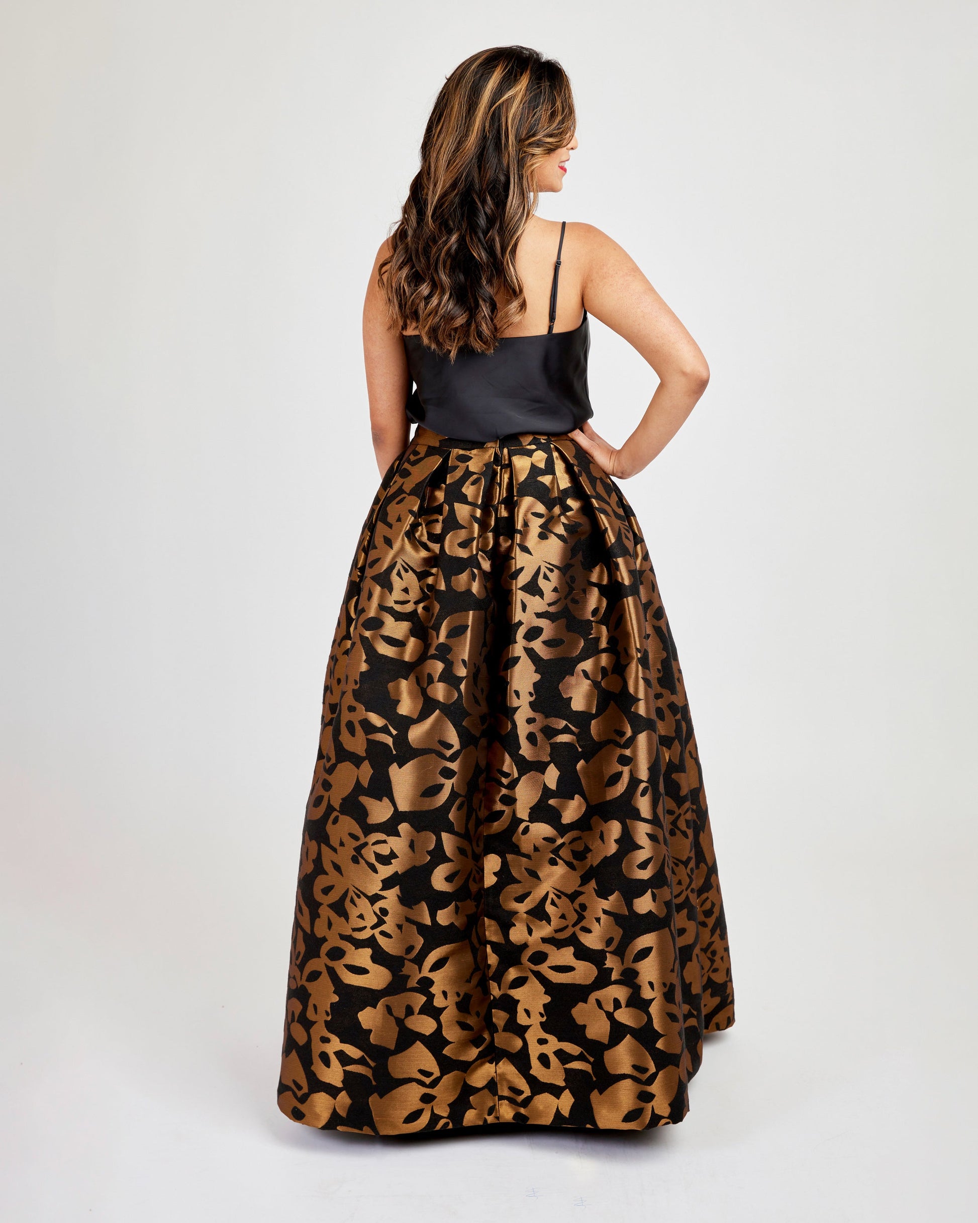 Woman wearing a black top and leopard print skirt on a white background. This skirt is the Upton Dress & Skirt sewing pattern from Cashmerette.